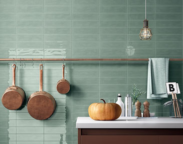 Cotagecore kitchen with lime tiles and a pumpkin