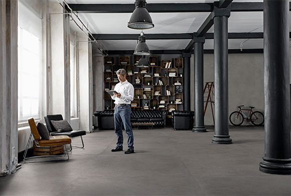 A man looks at a clipboard in a wide-open space